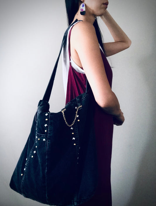 Black studded shoulder bag with animal print lining and chain