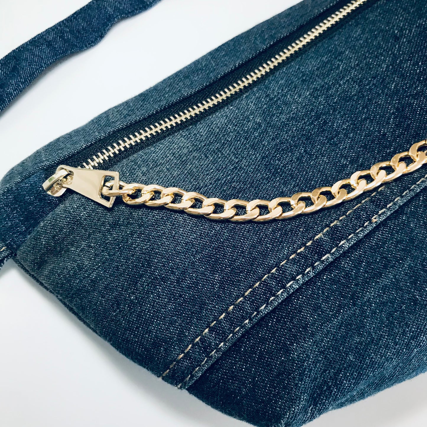 Indigo denim sling bag with gold chain detail