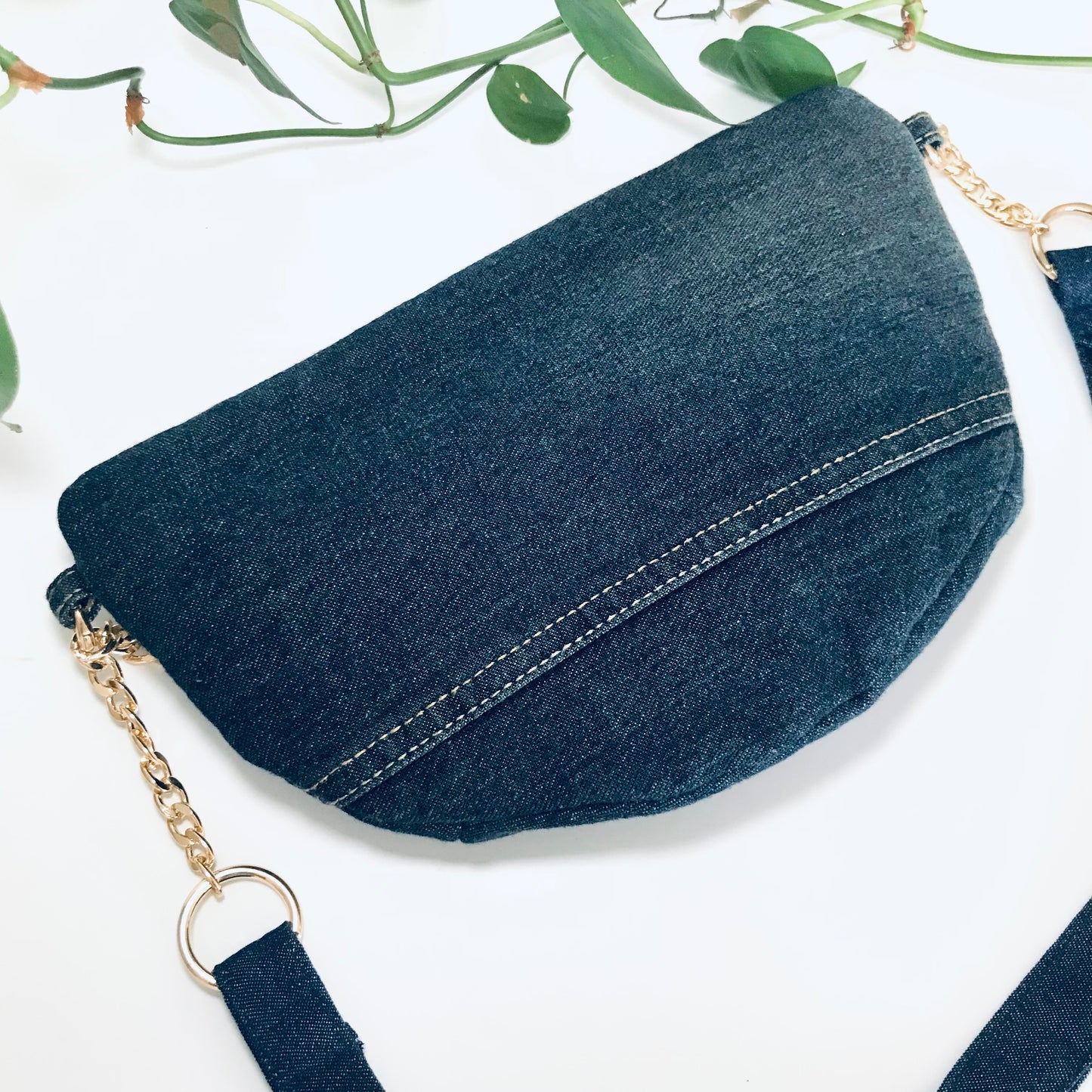 Indigo denim sling bag with gold chain detail