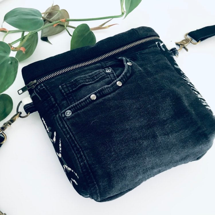 Upcycled denim crossbody adventure bag with black and white lining