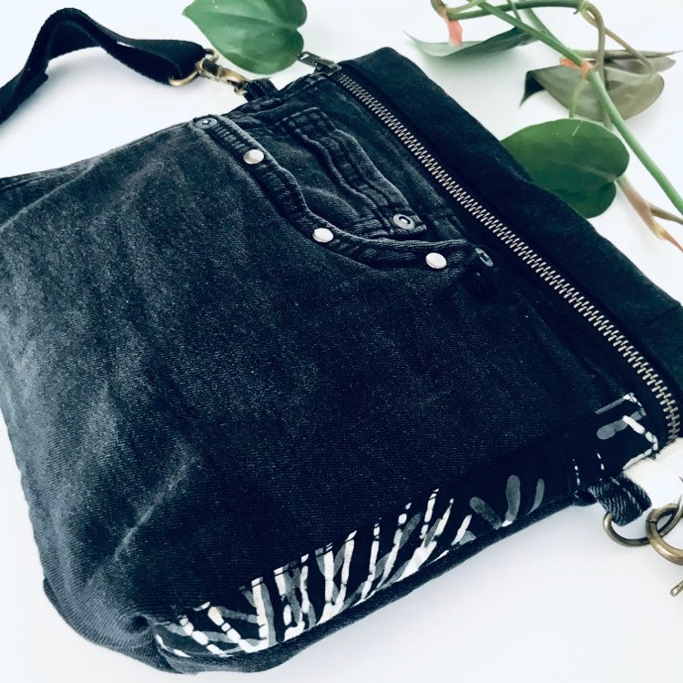 Upcycled denim crossbody adventure bag with black and white lining