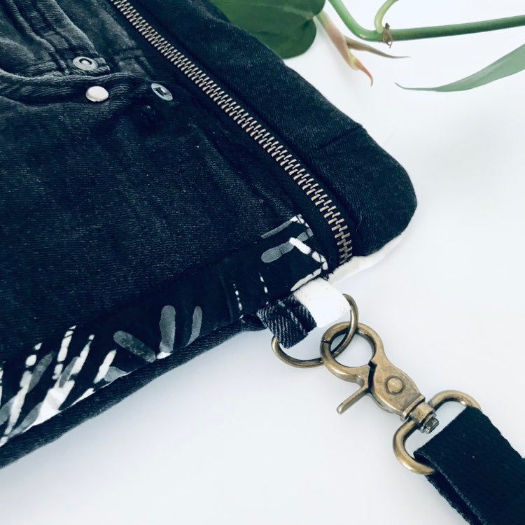 Upcycled denim crossbody adventure bag with black and white lining