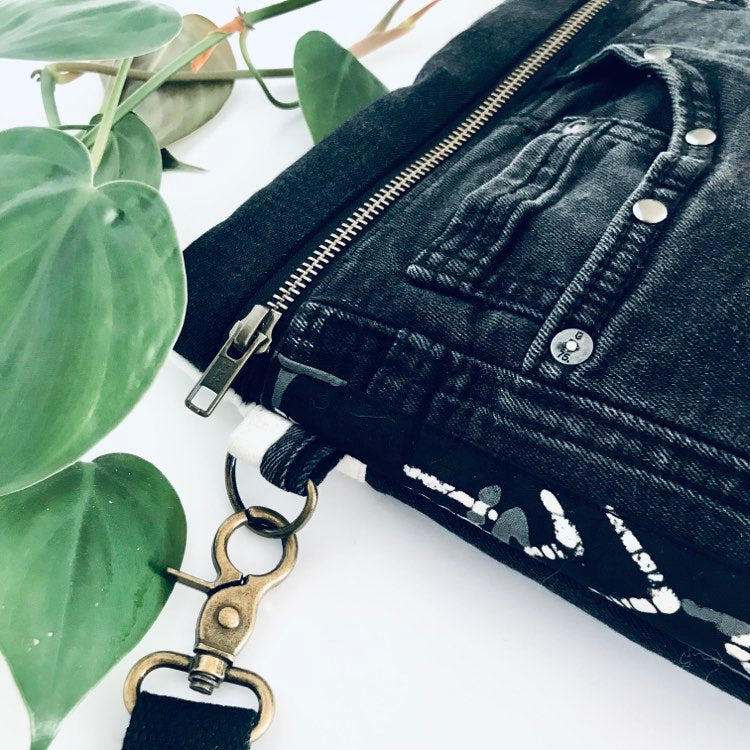 Upcycled denim crossbody adventure bag with black and white lining