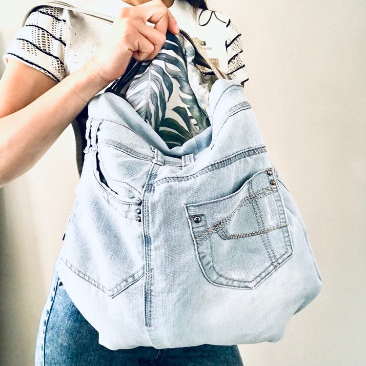 Upcycled denim hobo bag with tropical forest lining